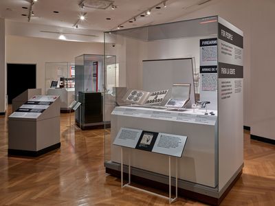The interior of the Forensic Science on Trial exhibition. Several large cases with objects and text panels are visible.
