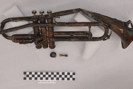 A trumpet recovered from the USS Houston undergoes treatment at the Naval History and Heritage Command's Underwater Archaeology Branch laboratory on the Washington Navy Yard, Dec. 31, 2013.