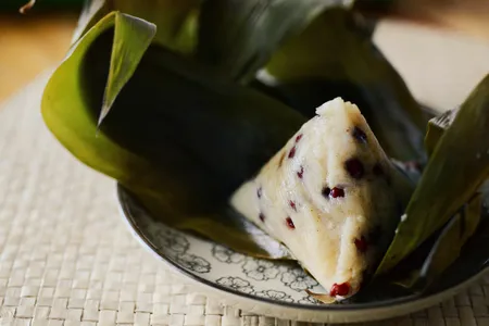 Zongzi are dumplings made from sticky glutinous rice wrapped neatly in a bamboo leaf and filled with umami-rich ingredients, like marinated pork, shiitake mushrooms, peanuts and beans.