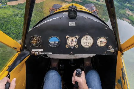 Instructor Erin Brueggen of CubAir enjoys the Wisconsin breeze in her 1946 Piper JC3 Cub in May 2021.