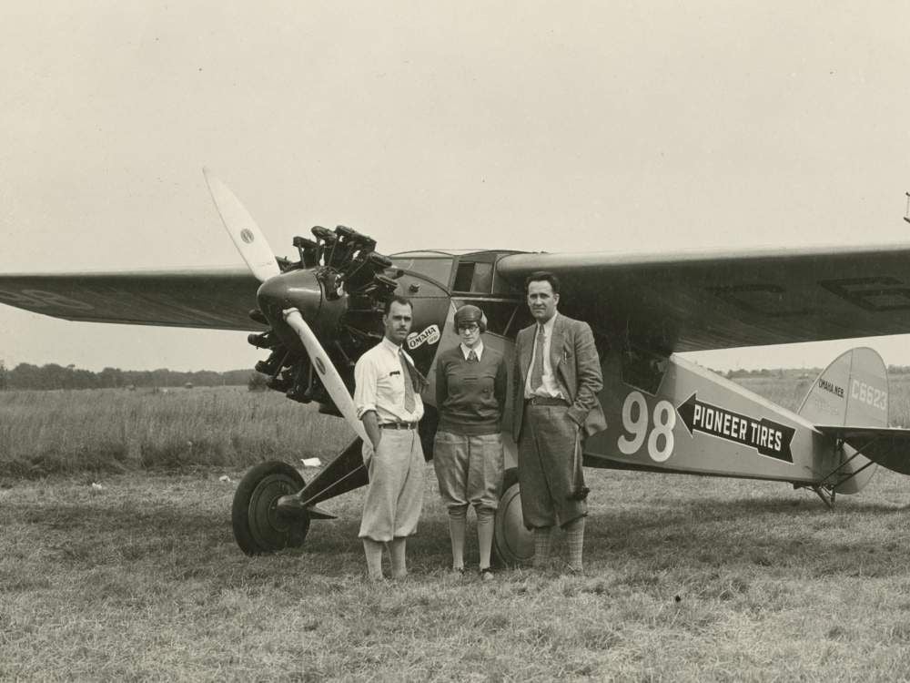 Three-quarter left front view of Cessna BW-5 (r/n C6623, National Air Races race no. 98) on the ground, possibly at Roosevelt Field, Long Island, New York, circa September 1928. Posed standing beside nose of aircraft are pilot Francis D.