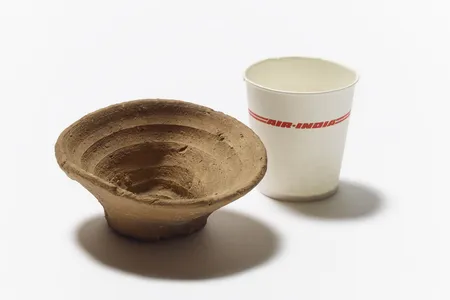 Minoan single-use cup alongside a paper cup from Air India