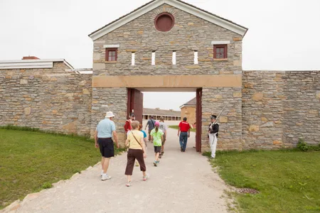 Visitors enter Historic Fort Snelling. A new exhibition at the site examines the fort's long, complex history.