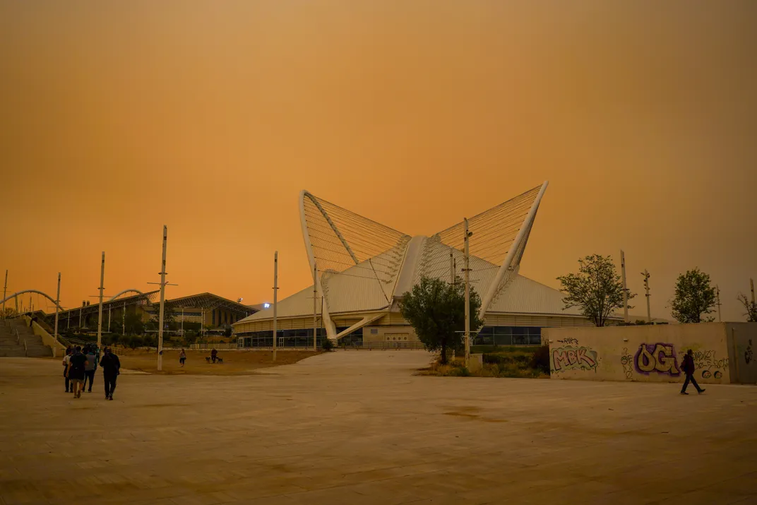 Saharan dust turns the sky a hazy orange color, as seen from the ground outside Athens' Olympic stadium.