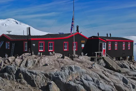 Penguins surround the post office at Port Lockroy, a British outpost on Goudier Island.