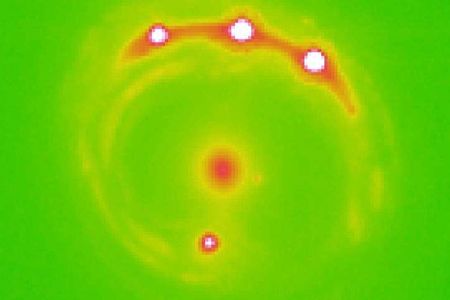 Researchers estimate more than a trillion planets could exist in the elliptical galaxy at the center of this image.