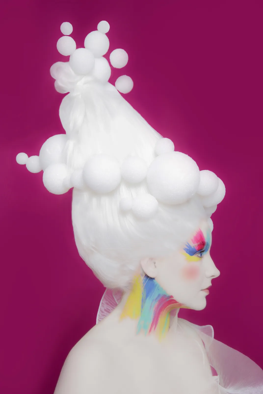 Woman with fanciful hairdo and rainbow neck