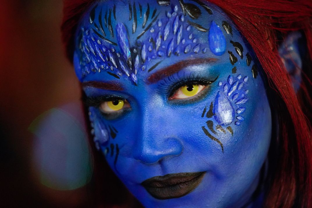 15 - With a blue hue similar to that of the X-Men mutant Mystique, a Halloween parade attendee takes to the streets of the Big Apple.
