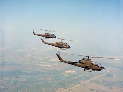 Bell Helicopter’s prototype for the AH-1G Cobra flies in front of two UH-1 Hueys, the aircraft it was designed to protect.
