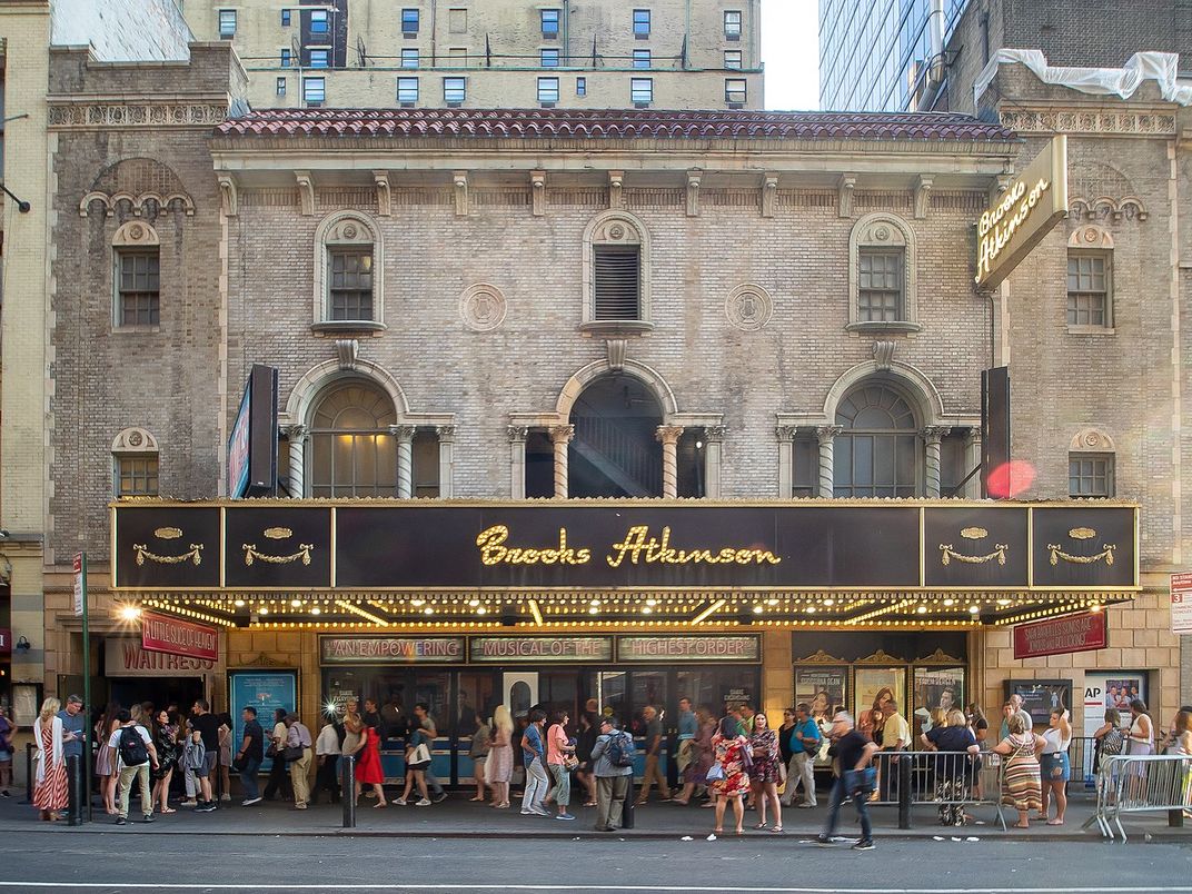 People in front of a Broadway theater