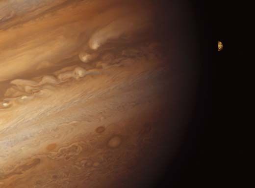 Io rising over Jupiters night side
