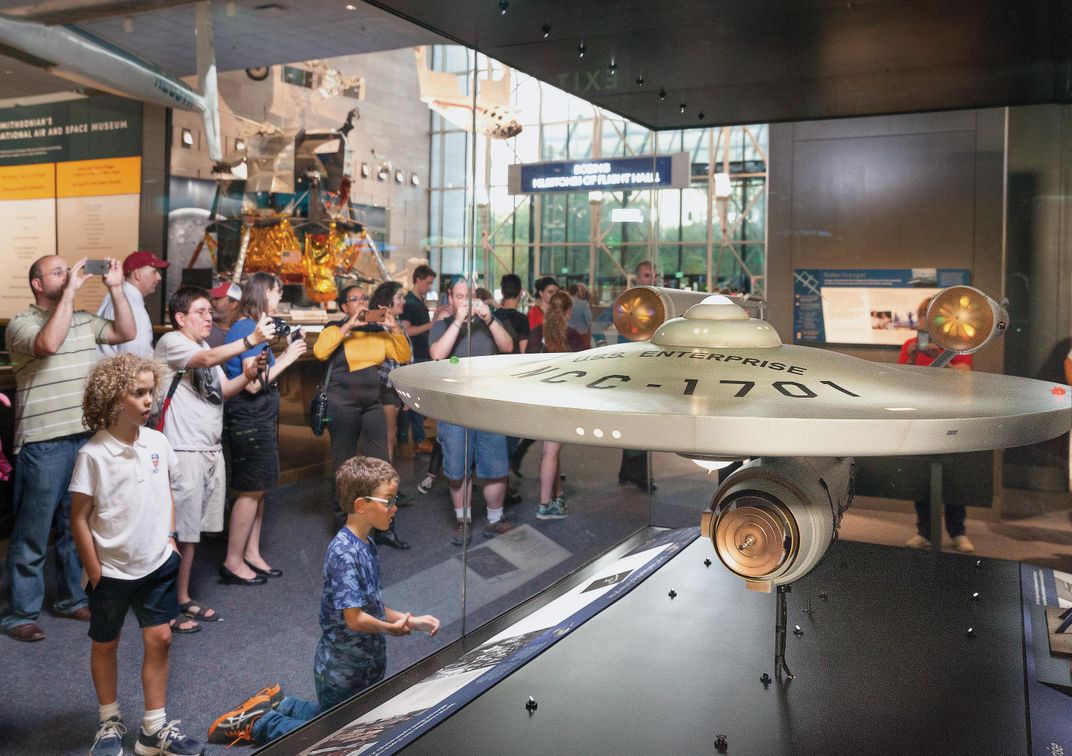 museumgoers look at studio model of Enterprise