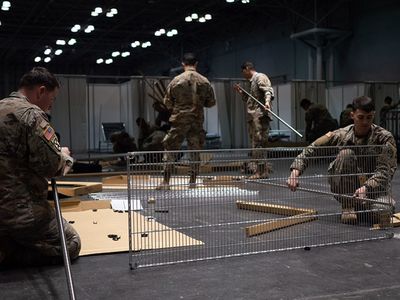 Soldiers assigned to the 531st Hospital Center build shelving at the Jacob K. Javits Convention Center in Manhattan, where a temporary medical station has been constructed to aid efforts combating the COVID-19 pandemic.