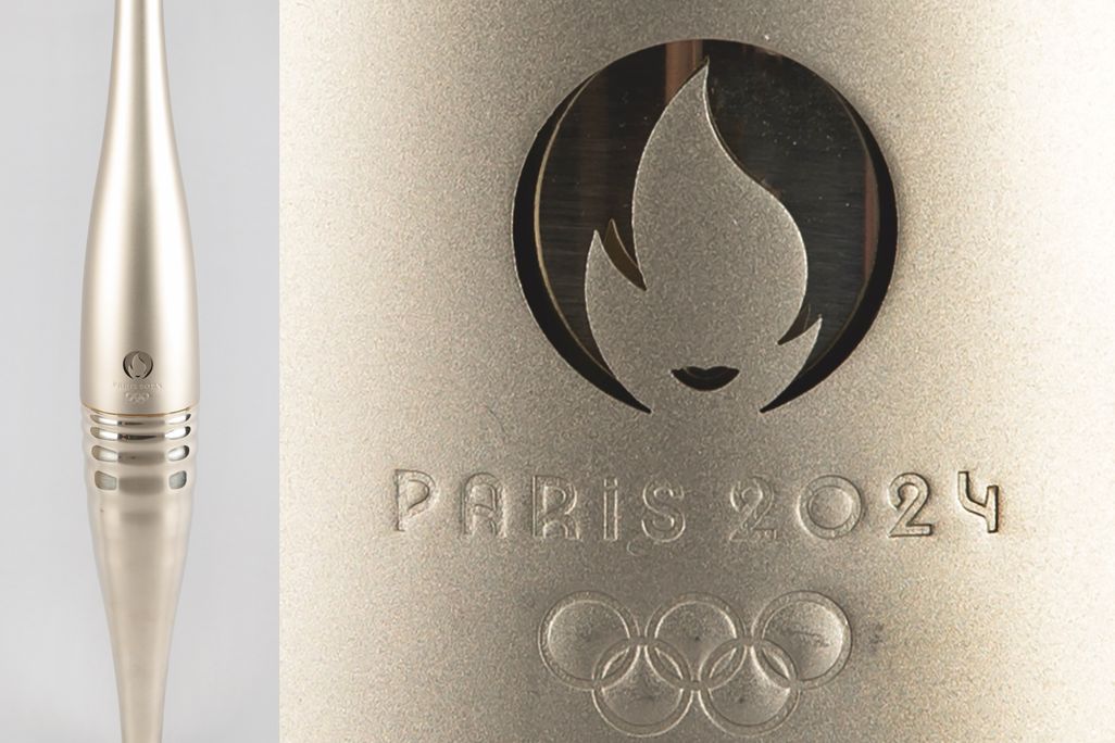 A long slender metal tube next to a close-up show of the Paris 2024 Olympics logo