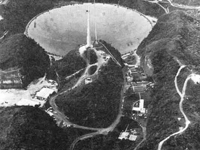 Arecibo Observatory in Puerto Rico with its 300 m (980 ft) dish, one of the world's largest filled-aperture (i.e. full dish) radio telescope, conducts some SETI searches.