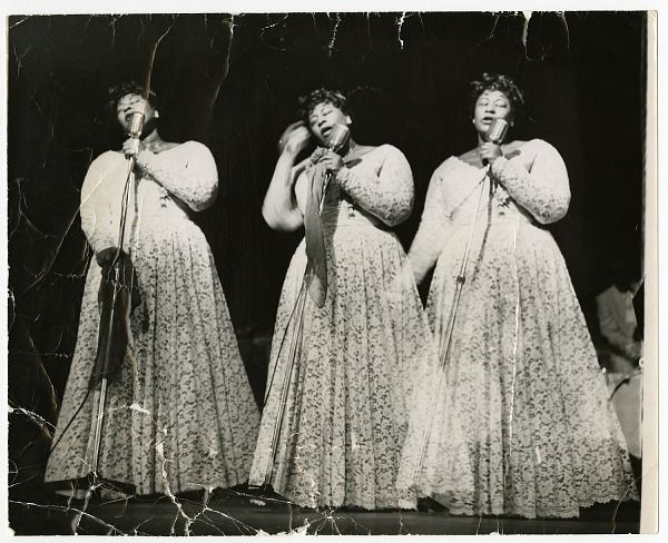 Three images of Ella Fitzgerald, side by side. Her eyes are closed as she sings into the microphone she is holding in front of her.