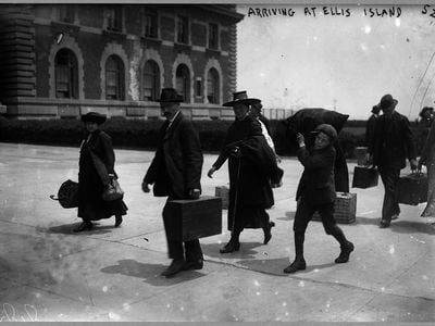 Immigrants arriving at Ellis Island with their possessions in 1907.