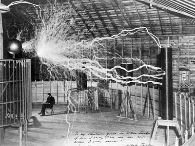 The inventor at rest, with a Tesla coil (thanks to a double exposure).