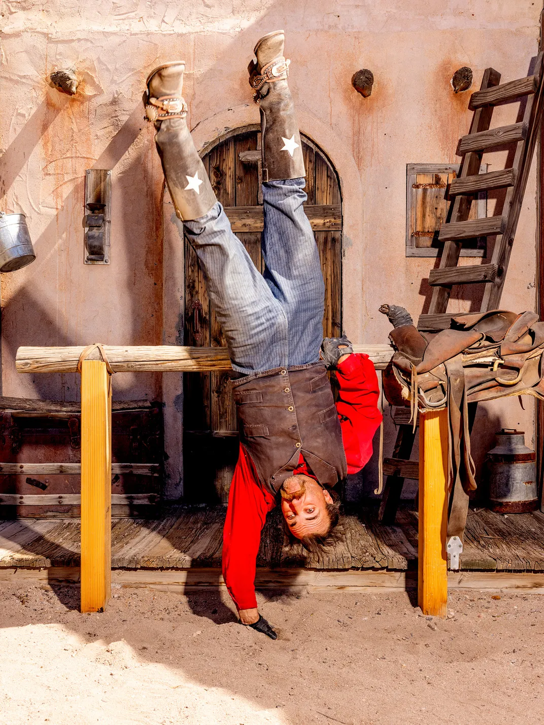 a cowboy does a handstand