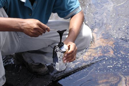 A student samples the goo at Pitch Lake in Trinidad. 