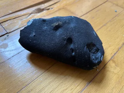 A person who discovered and approached the possible meteorite said it felt warm to the touch.