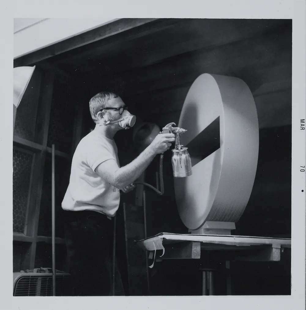 Photograph of artist Tony DeLap working in his studio