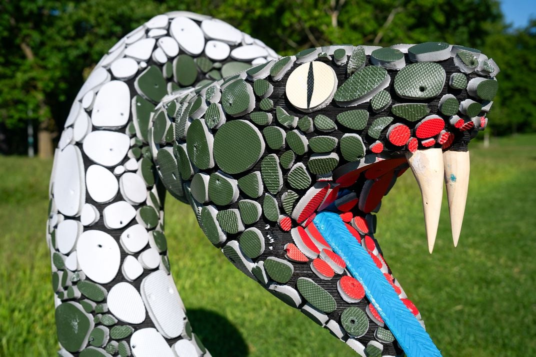 Snake sculpture with open mouth