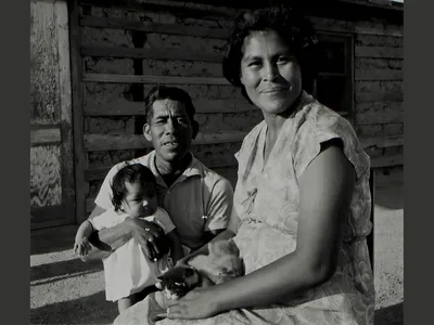 Patricia Stone (Akimel O'otham) and Leonard Stone (Akimel O'otham) with their new baby, 1965. Gila River Indian Community, Arizona. (Helge Teiwes Collection, NMAI.AC.070)