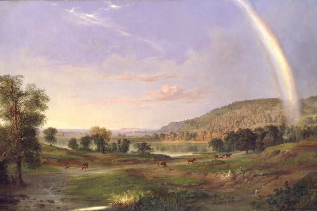 A landscape painting looking over a gently sloping green field dotted with cows and a couple walking in the distance; the man gestures out at a large rainbow extending through the right of the canvas, into the blue-purple sky