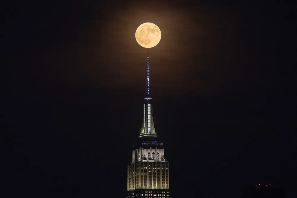 Strawberry moon rises behind the Empire State Building in New York City on June 29, 2026
