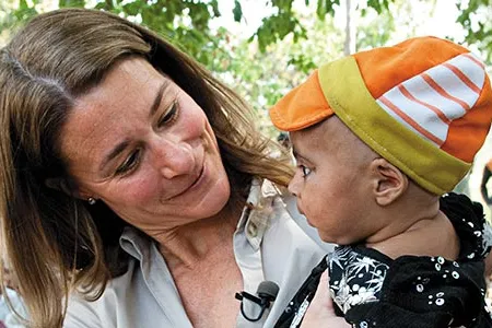 Melinda Gates, with caregivers in Rampur Bhuligadha, India, says infant deaths can be halved by 2025.