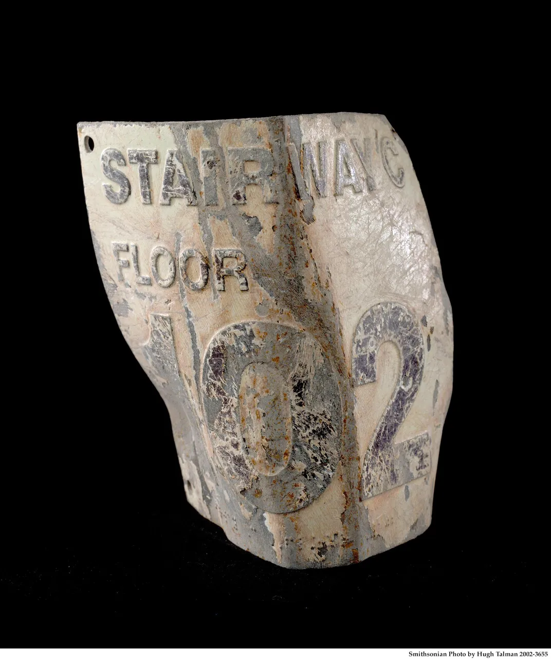 This damaged floor marker, labeled “Stairwell C, Floor 102,” was recovered from the debris of the World Trade Center.