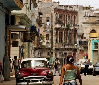 Cubans had fought vehemently for independence from Spain from the 1860s to the 1890s, but by the 20th century, the country had become beholden economically to the United States (a Cuban street, with a classic American car, today).