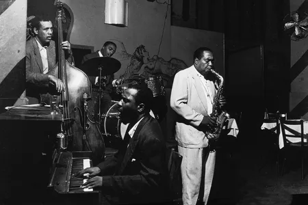 American jazz musicians Charlie Parker, on alto sax, and Thelonious Monk, on piano, perform at the Open Door Cafe, in New York City on September 14, 1953.
