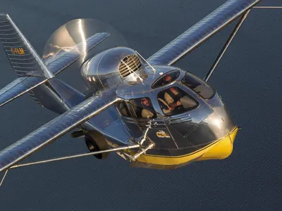 A Republic Seabee, the ideal sportplane, climbs over a Wisconsin lake.