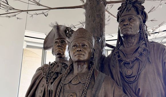 Detailed photo of a bronze sculpture depicting George Washington, Polly Cooper, and Skenandoah from the waist up.