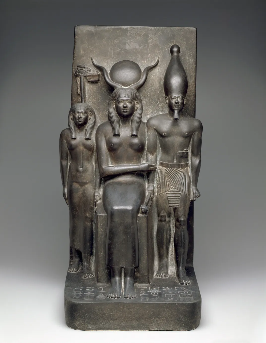 The goddess Hathor, King Menkaure and the Deified Hare nome in a stone sculpture dated to between 2490 and 2472 B.C.E.