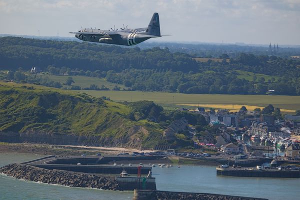 USAF C-130J with invasion marking flying near the OMAHA beach in Normandy thumbnail