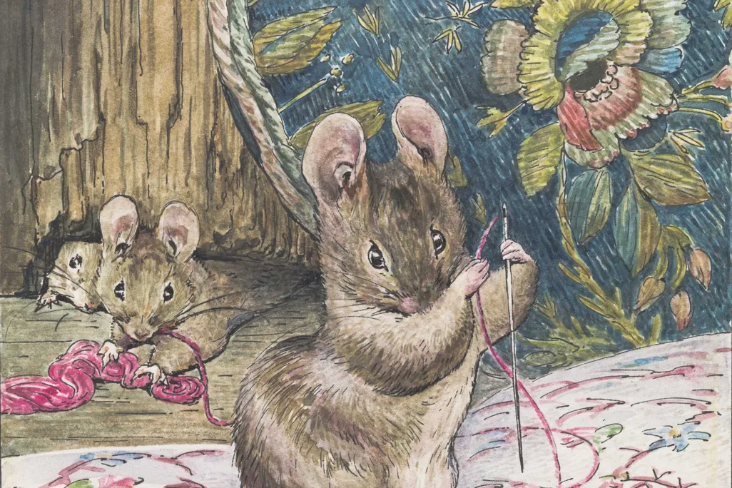 A brown mouse holds a needle and piece of pink thread and works on a delicate embroidery pattern of pink, blue and green flowers on white cloth, while two mice look on behind