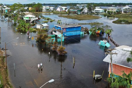An aerial view from September 17 shows people walking through a flooded street after Hurricane Sally passed through Gulf Shores, Alabama.