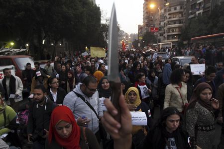 A woman raises a knife and shouts slogans against then Egyptian President Mohamed Mursi and the Brotherhood during a march against sexual harassment and violence against women in Cairo, February 6, 2013. 