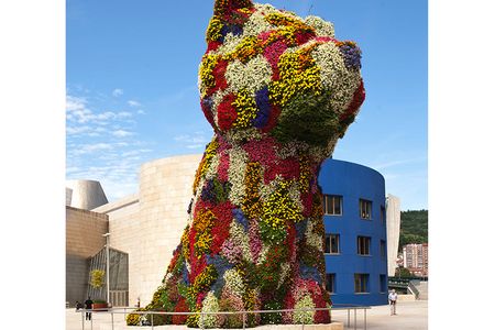 Artist Jeff Koons admires his Puppy (1992). Carpeted in colorful swaths of flowering plants, the 41-foot-tall Westie joined the Guggenheim Bilbao’s permanent collection in 1997 and stands in the square just outside the museum entrance.