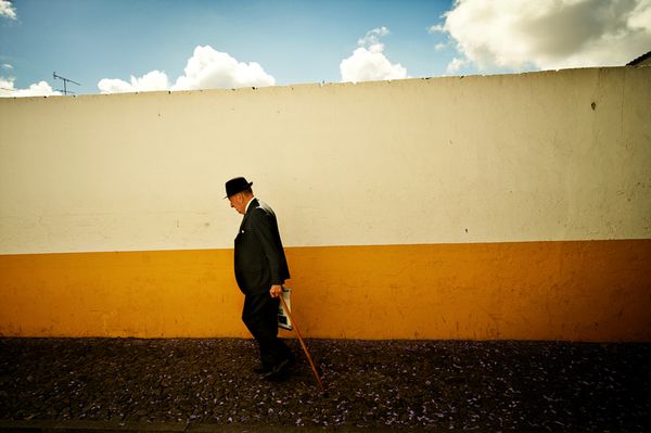 Old man walkin on the UNESCO word heritage streets of Evora thumbnail