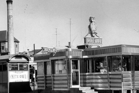 This 1956 photograph was taken during the short time that two Nite Owls sat cheek-by-jowl in Fall River, MA. Soon the old lunch wagon was carted away and demolished, replaced by the gleaming diner.