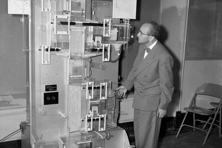 A MONIAC at Roosevelt College, pictured with economics professor Abba P. Lerner