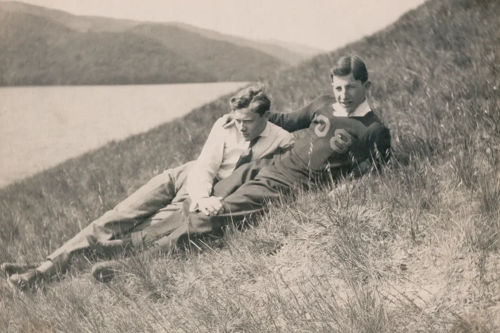 Black and white photo of two men on a hillside