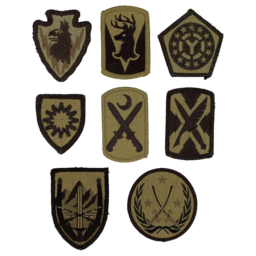 Eight insignia patches decorated with symbols, including elk, moons, swords, and stars.
