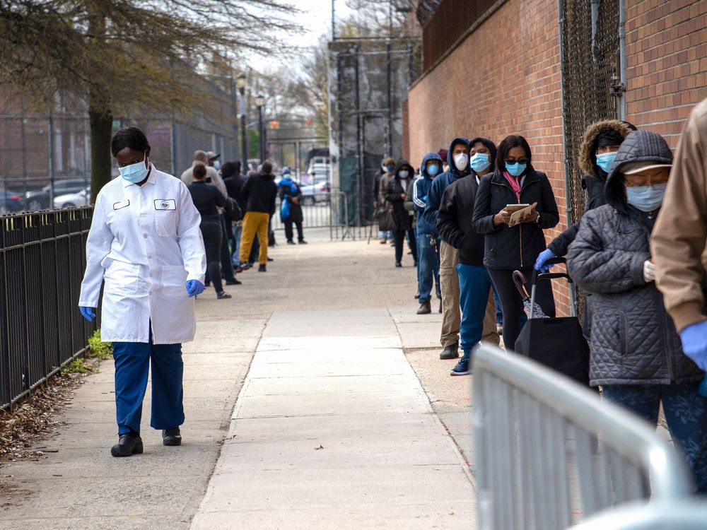 a line, mostly of people of color, waiting for COVID-19 tests in Brooklyn