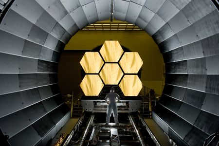 A scientist looks at mirror segments for the NASA's James Webb Space Telescope. The mirrors underwent cryogenic testing—made possible by scarce helium gas—to see how they would respond to extreme temperatures. Now, scientists have found a huge cache of helium gas that could make the element more accessible to scientists. 