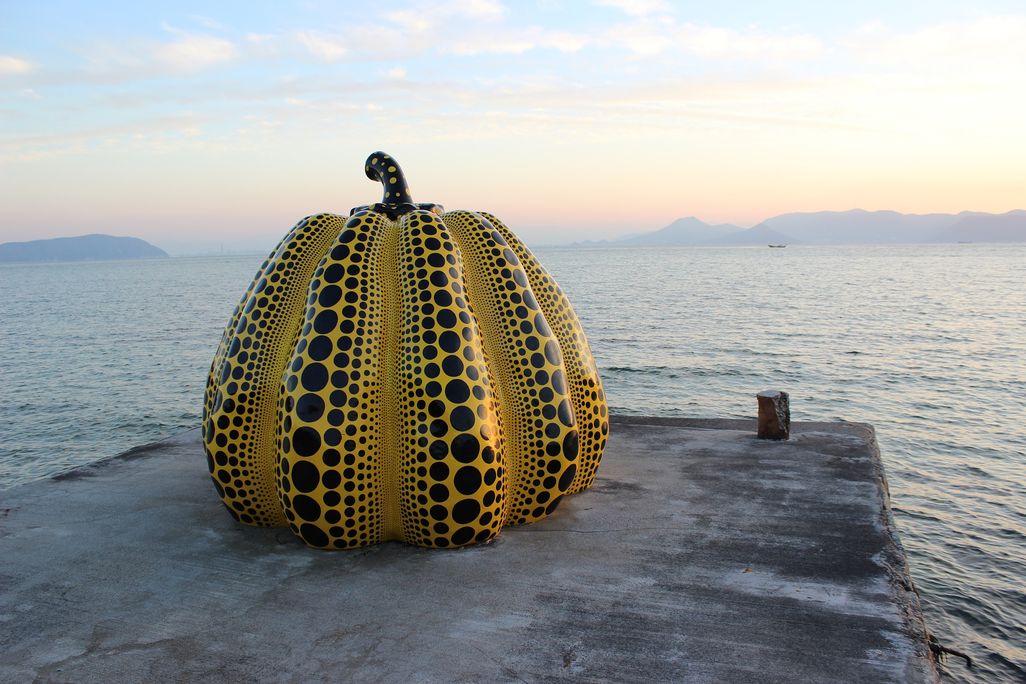 Yayoi Kusama Pumpkin sculpture on a pier
